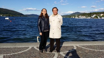 Mariangela and Grandmaster Wong in front of Wörther Lake with crystal blue wate